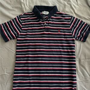 Classic striped navy, red, and white polo shirt with a collared neckline